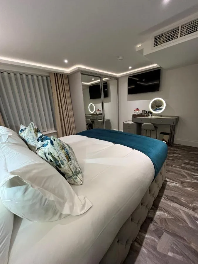 a bedroom with a large white bed with pillows at Philharmonic Hotel in Liverpool