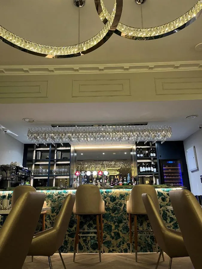 a bar at a restaurant with chairs and a counter at Philharmonic Hotel in Liverpool