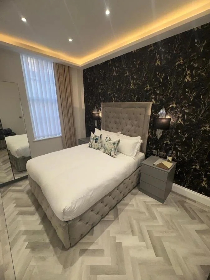 a bedroom with a large bed and a black wall at Philharmonic Hotel in Liverpool